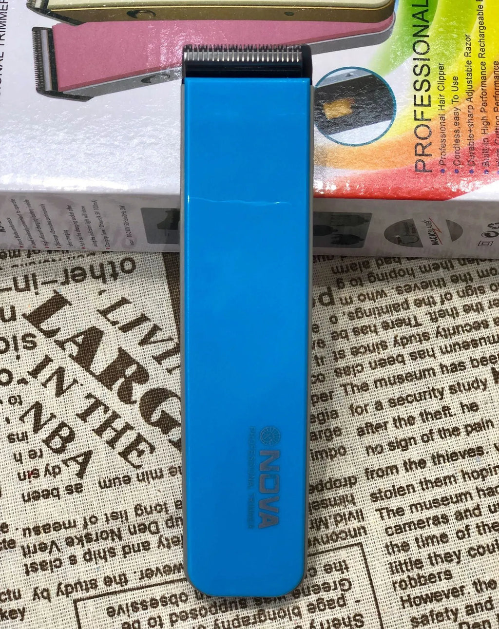 Electric hair clipper with removable blade head in black, blue, orange, red, or white colour options