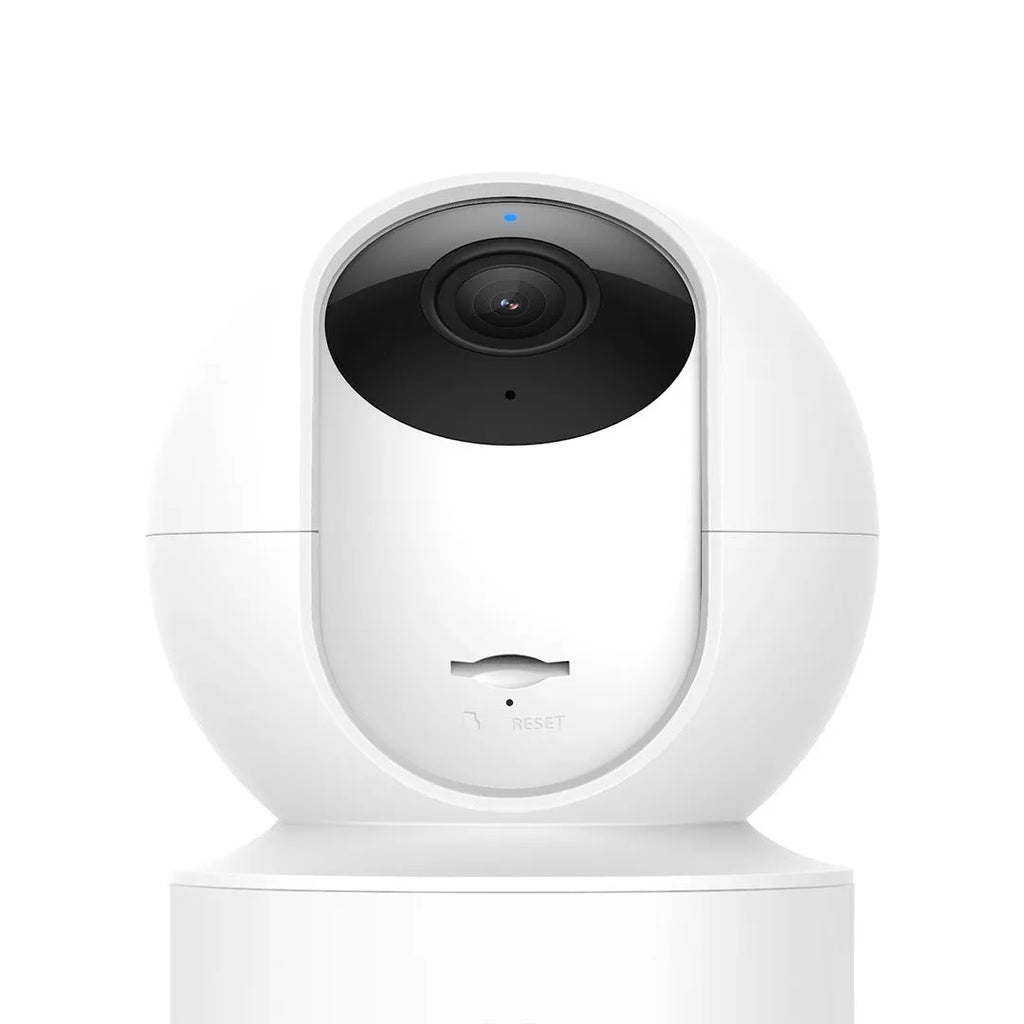 White Xiaobai smart security camera on a surface showing its compact design.