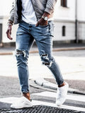 Men's light blue straight fit distressed jeans with embroidered details and zip fly