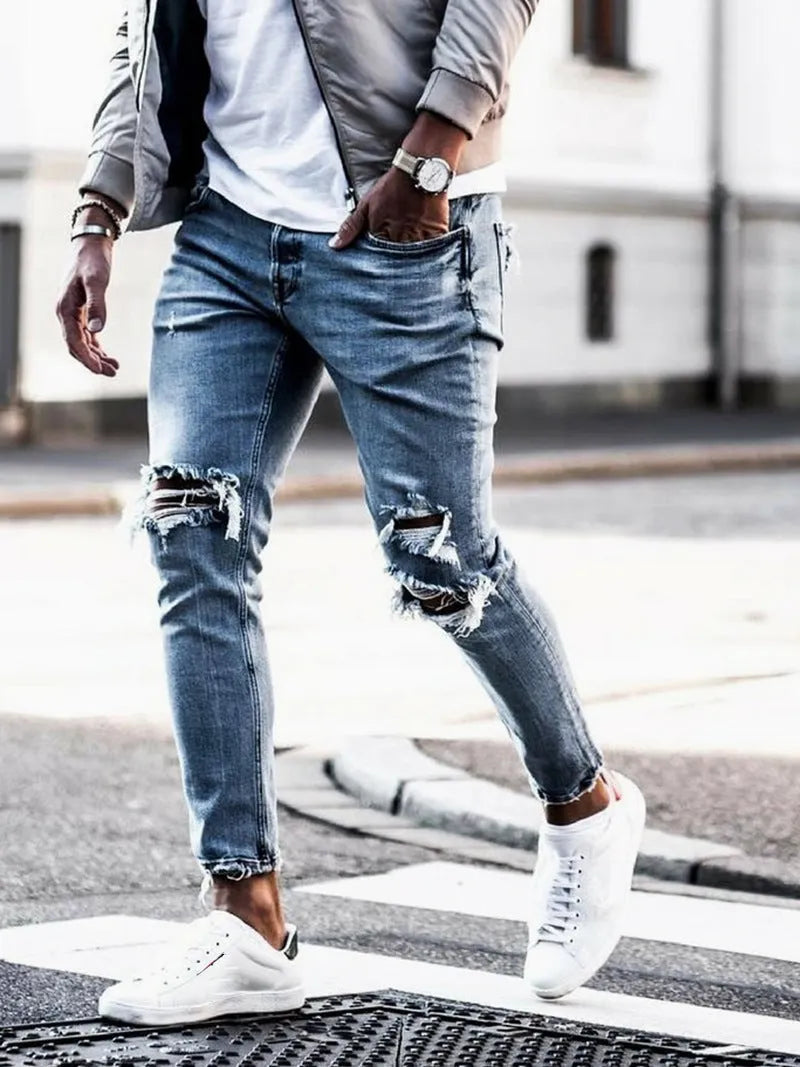 Men's light blue straight fit distressed jeans with embroidered details and zip fly