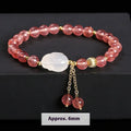 Women's strawberry quartz and agate bracelet with 6mm round beads and a white rabbit charm pendant.