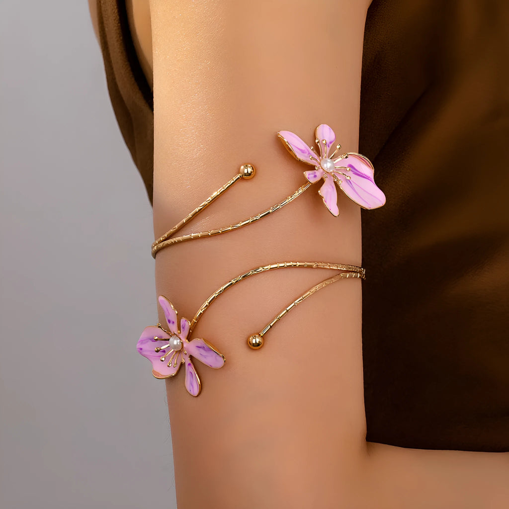 Pink alloy armband with hollow line pattern, shown as an open cuff bangle.