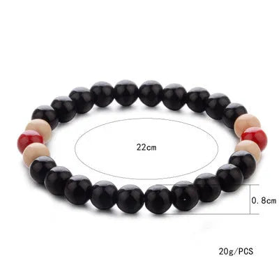 Natural stone bead bracelet with lava stones on wrist, showing ethnic unisex design.