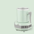 White mini cooling cup with semiconductor refrigeration base on desk