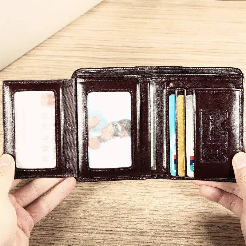 Men's brown leather bifold wallet open to show multiple card slots, a cash compartment, and a coin pocket.