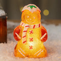 Plastic glowing gingerbread man Christmas ornament with a scarf in red, white, or transparent colours.