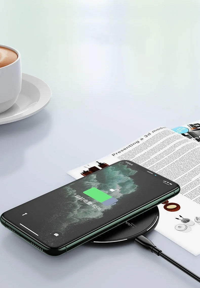 Black Kuulaa KL-CD16 wireless disc phone charger on a surface with LED light on.