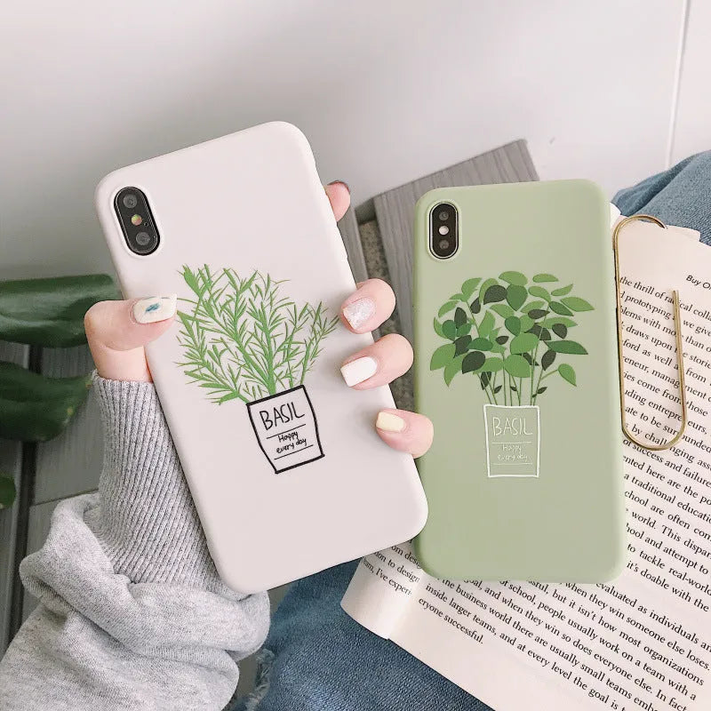 White silicone iPhone case with a painted green plant pattern on the back.
