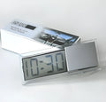 Dot matrix LCD car clock with suction cup mount placed on dashboard