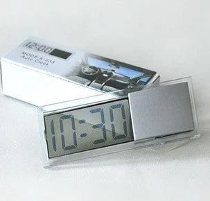 Dot matrix LCD car clock with suction cup mount placed on dashboard