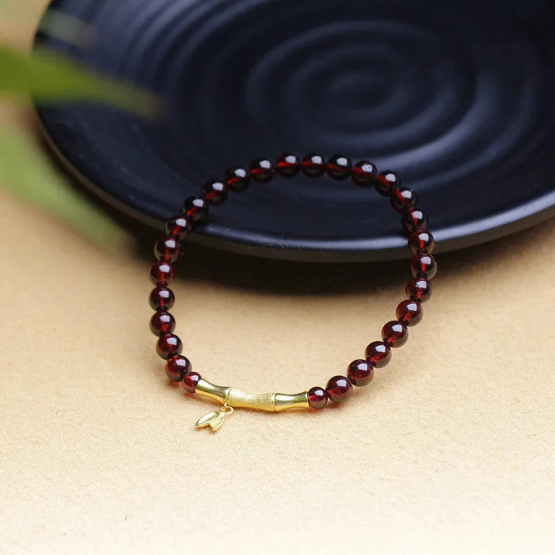 Natural garnet stone set in a 6mm bamboo joint ring bracelet with copper or silver finish.