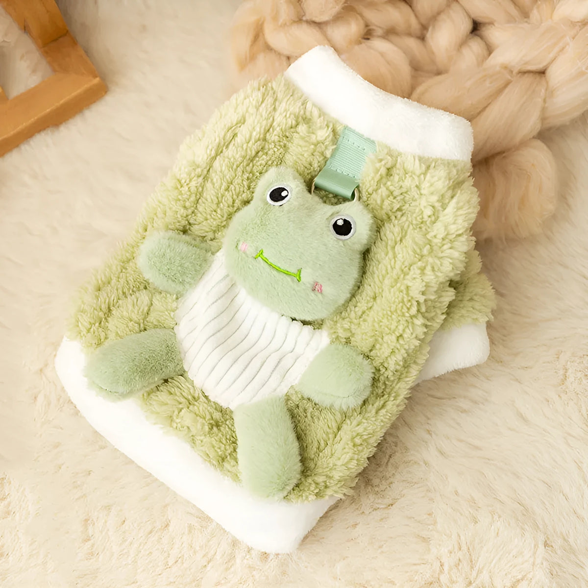 Green plush fleece dog hoodie with 3D frog face, white trim, and D-ring on belt for lead attachment.