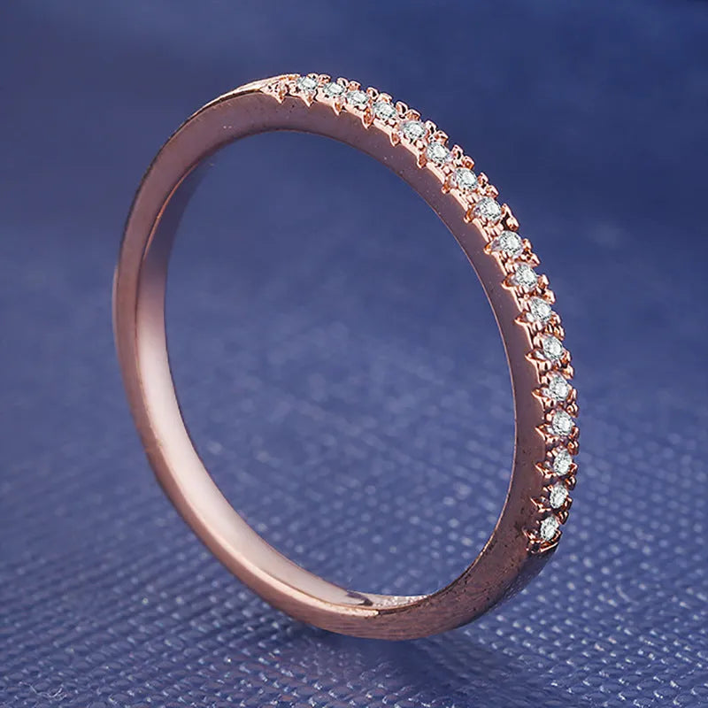 Women's crystal band ring in rose gold finish with cubic zirconia stones, US size 7