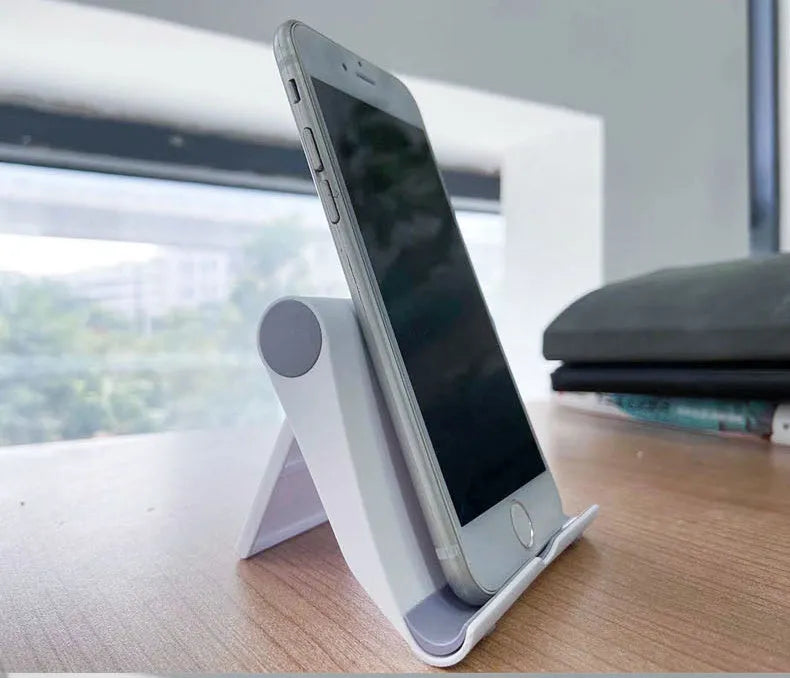 PE folding tablet and mobile phone stand in an adjustable open position on a desktop.