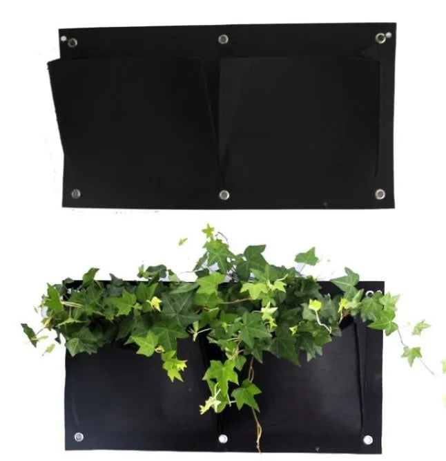 Vertical felt wall garden planter with multiple green planting pockets hung on a wooden fence