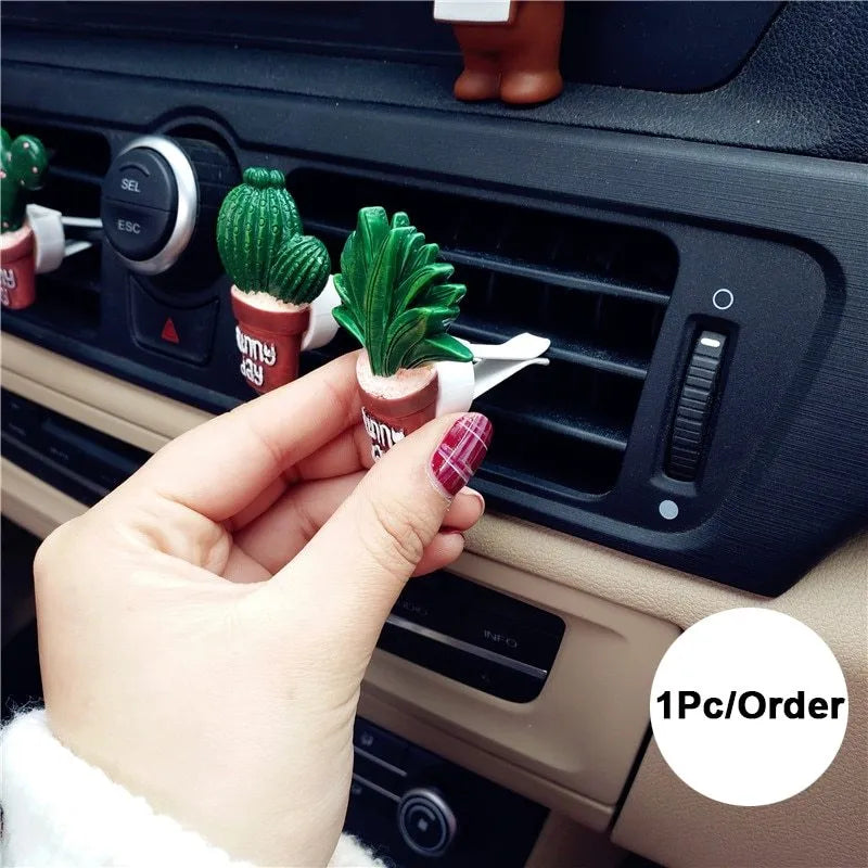 Cute green cactus car air freshener vent clip attached to car air conditioning vent