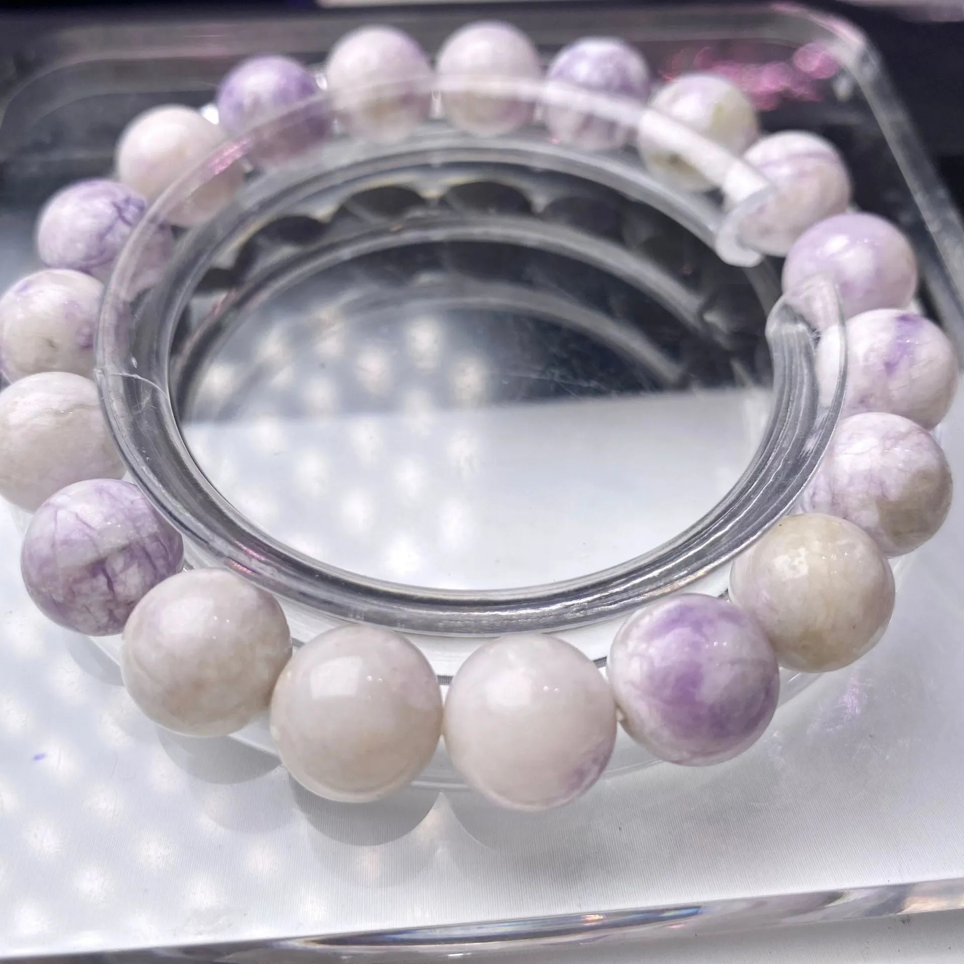 A purple turquoise bead bracelet for women showing round stone beads on a wrist.