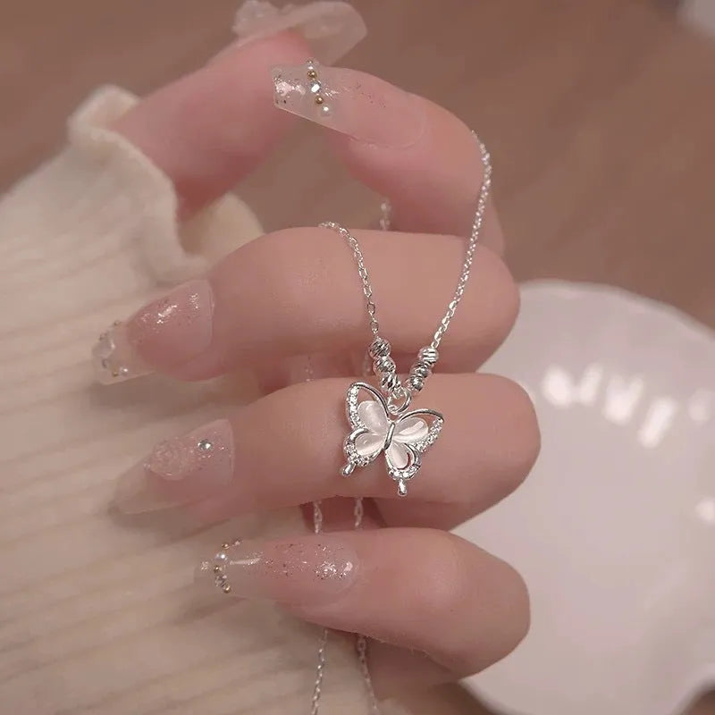 Silver square line opal butterfly pendant necklace on a cross chain for women.