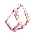 Pink colourful dog harness with heart-shaped stones and gold buckle fastenings on chest and back support design