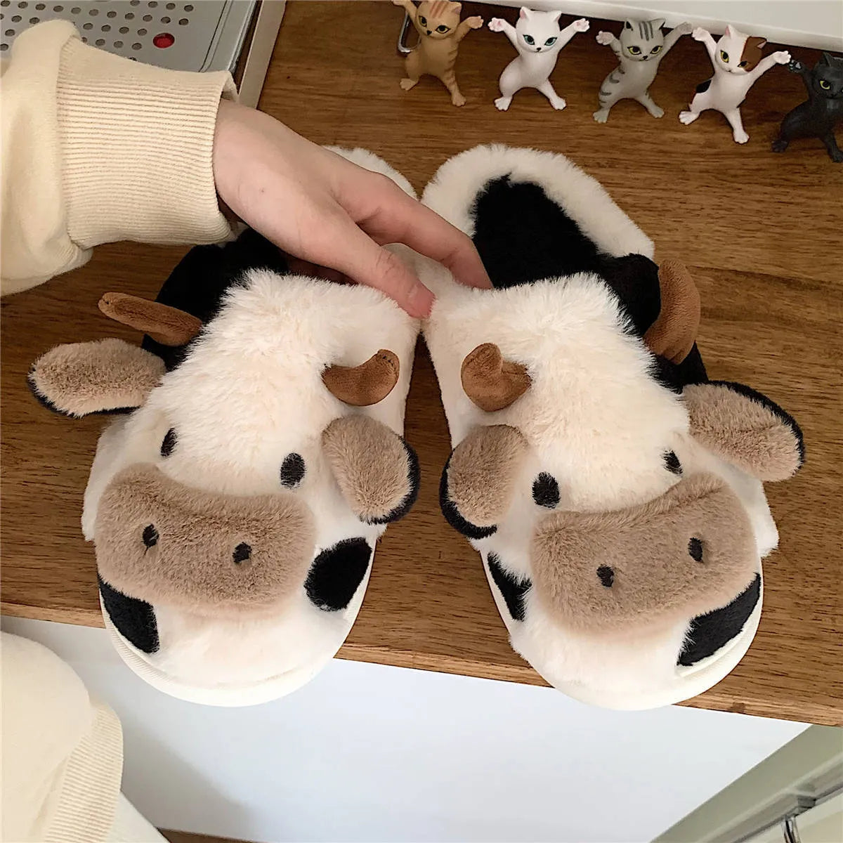 White cow-themed plush slippers for women with non-slip textured soles