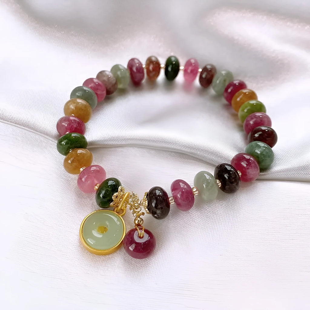 Colourful tourmaline bracelet with rabbit pendant and round abacus beads on wrist
