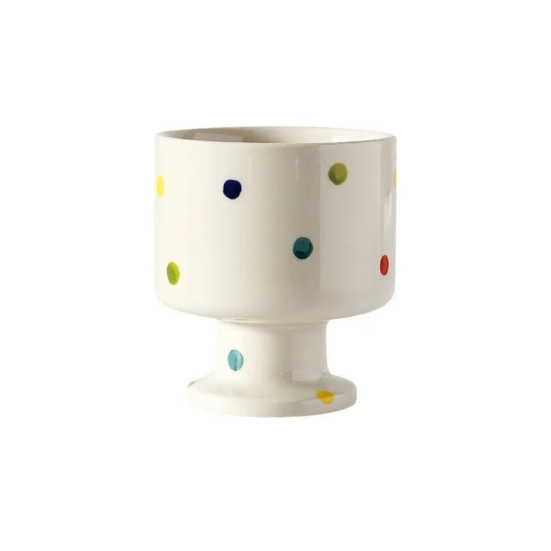 Hand-pinched irregular ceramic mug in a solid colour, showing its unique shape.