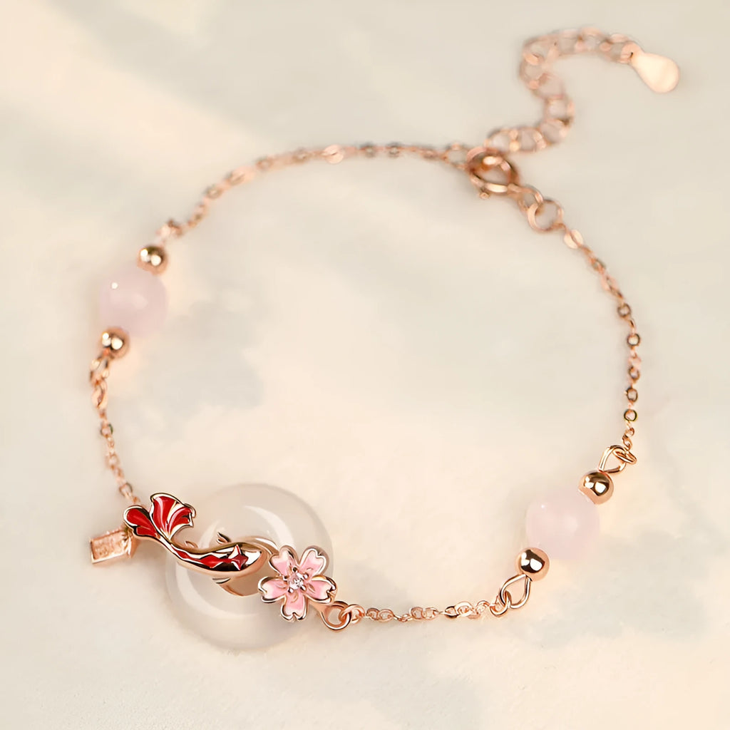 Women's sterling silver bracelet with Chinese floral design, white chalcedony crystal, and koi fish elements