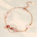 Women's sterling silver bracelet with Chinese floral design, white chalcedony crystal, and koi fish elements