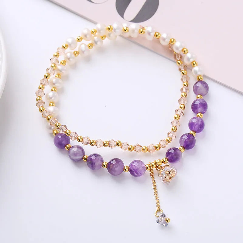 Handcrafted women's double ring crystal bracelet in amethyst, aquamarine, or strawberry quartz colour.