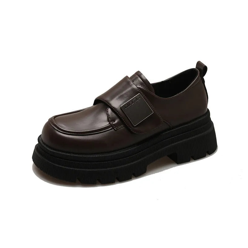 Women's black chunky heel shoes with low top, round toe, and cross strap detail on a white background