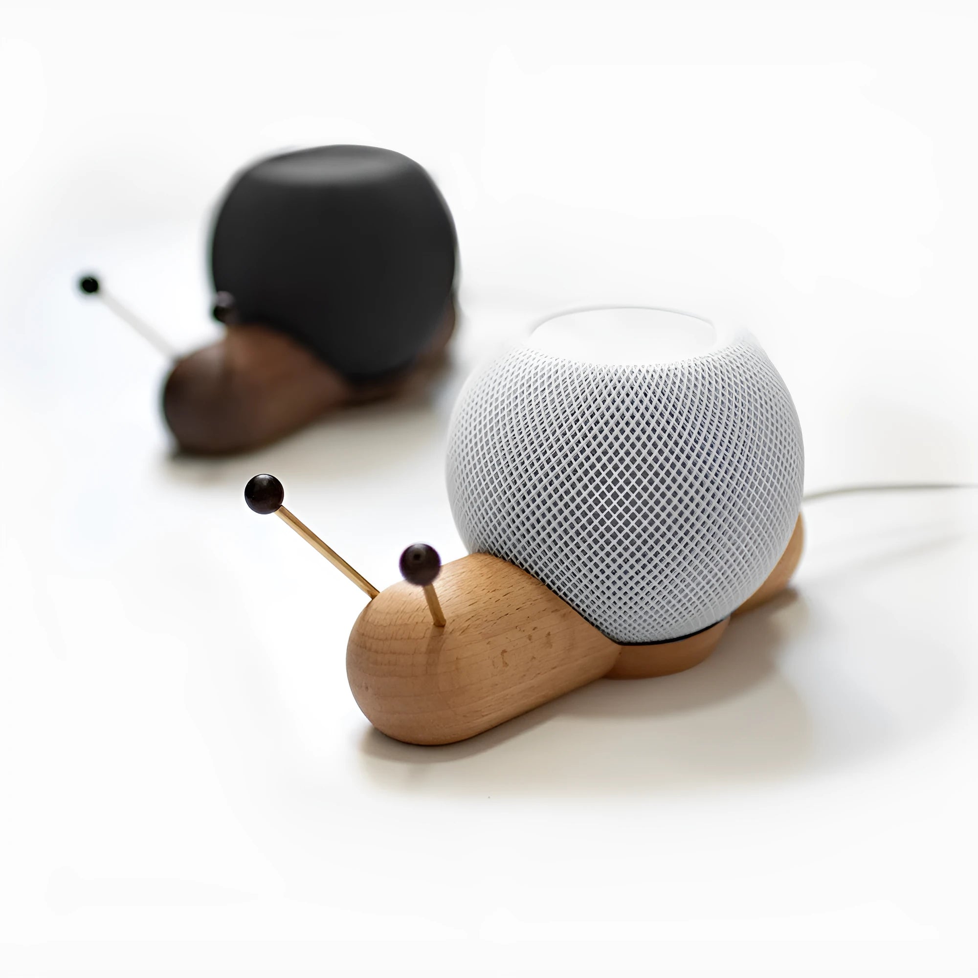 Coffee coloured non-slip desktop bracket for Apple HomePod speaker.