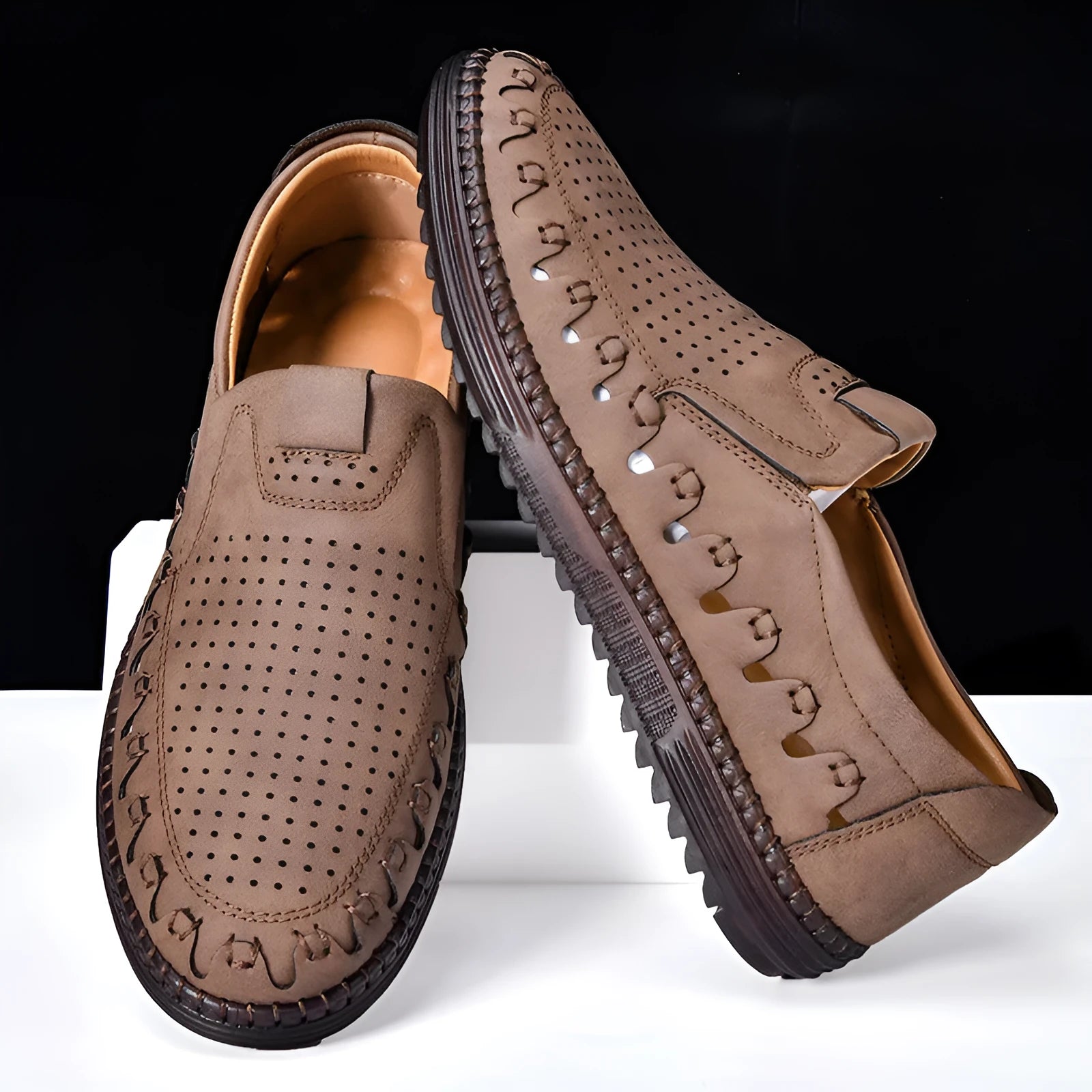 Men's brown casual slip-on shoes with round toe, low top, and sleeve entry design on a plain background.