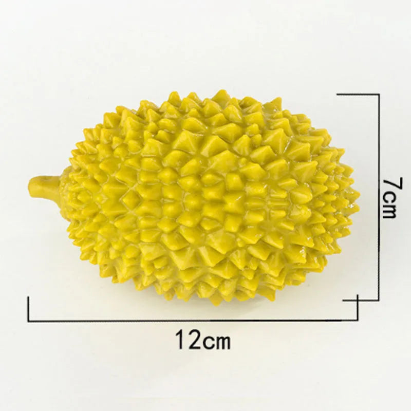 Durian-shaped dog chew toy in beige, green, and yellow colours with textured surface for teeth cleaning