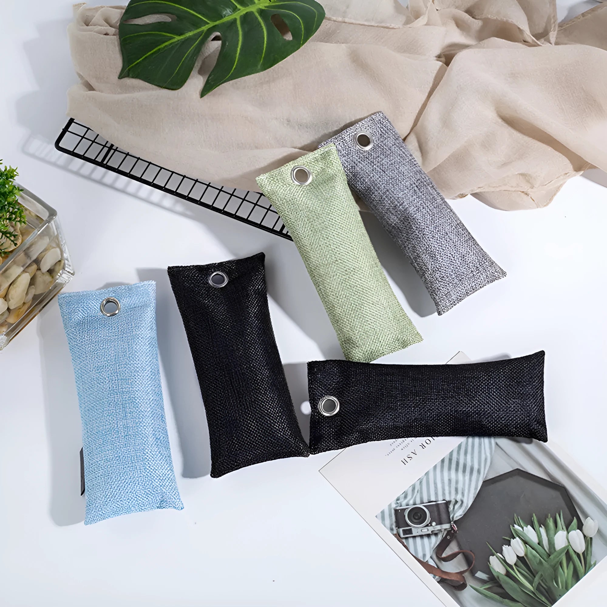 Black, green, grey and blue activated charcoal shoe deodoriser bags measuring 16.5cm.