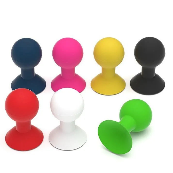 Creative silicone octopus ball mobile phone holder in blue on a desk with a smartphone inserted