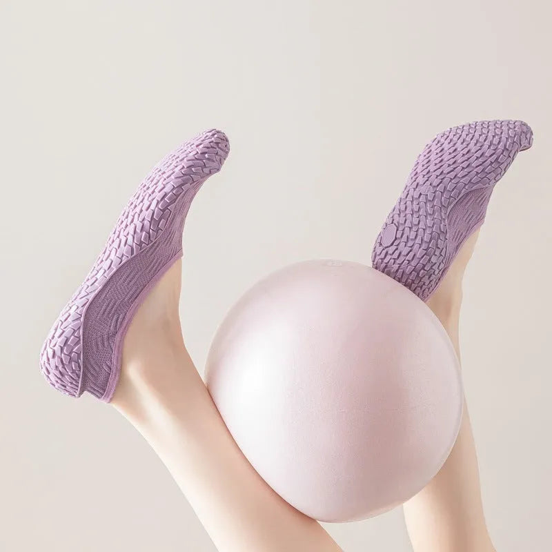Women's low-top indoor fitness shoes in a solid colour with a mesh upper and soft rubber sole.