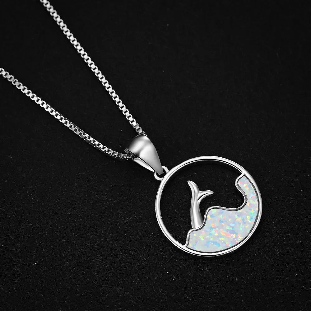 Geometric fishtail pendant necklace with a round blue opal on a silver-toned chain.