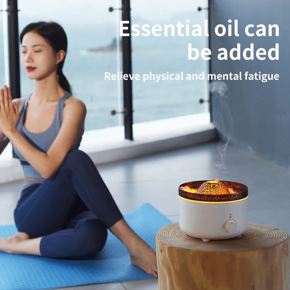 White columnar simulated flame volcano humidifier with remote control on wooden surface