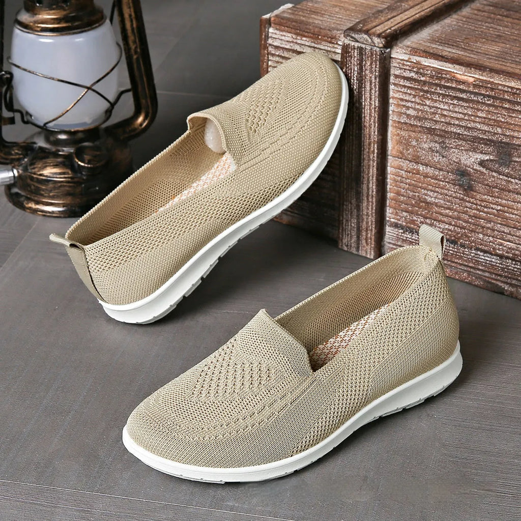 Plus size women's low-top leisure cloth shoes in beige with a heart-shaped pattern and flat sole.