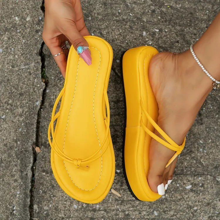 Pair of thick-soled herringbone style flip-flops on a plain background, shown in one of the six available colours.