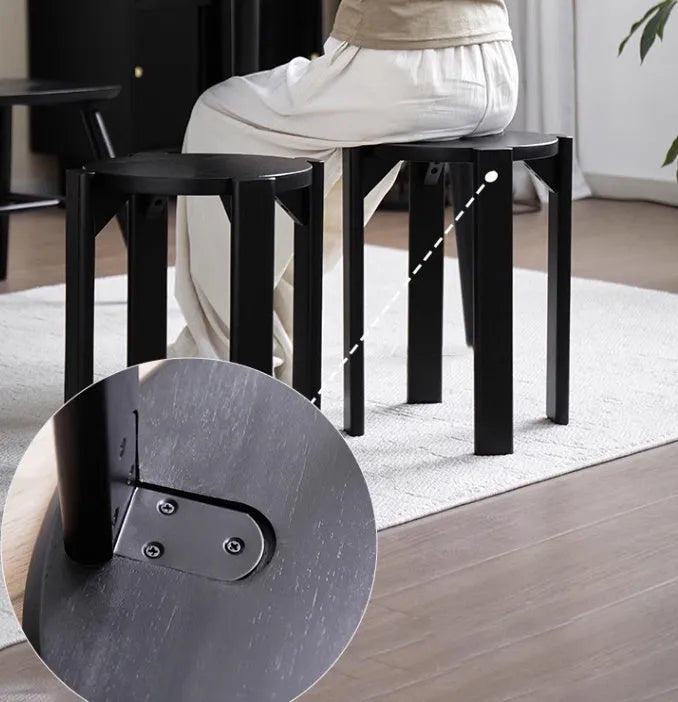 Stackable round iron dining stool in a modern style, shown in a choice of four colours.