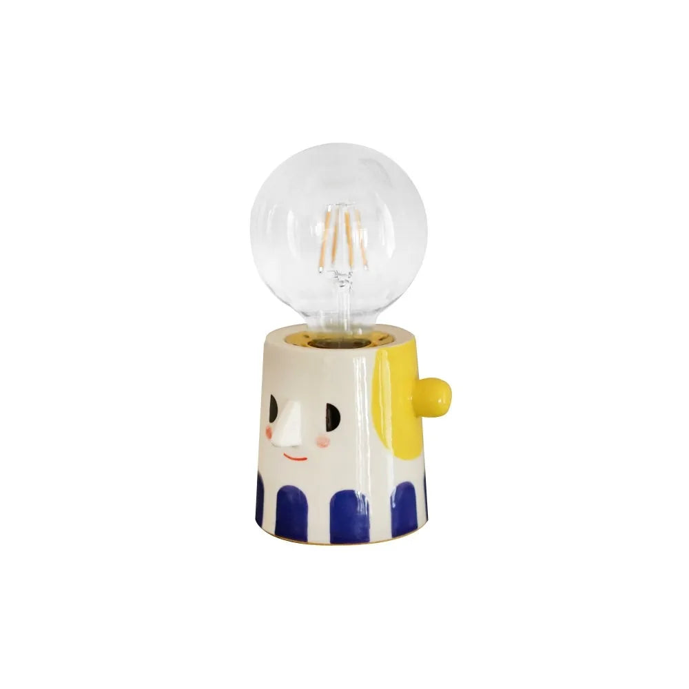 Handmade ceramic table lamp with a spherical white ball headlight shade on a solid base.