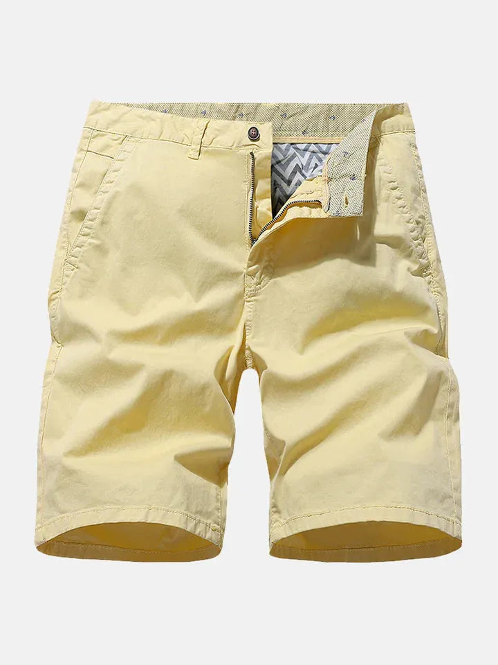 Man wearing loose-fitting blue denim casual shorts with a straight leg cut.