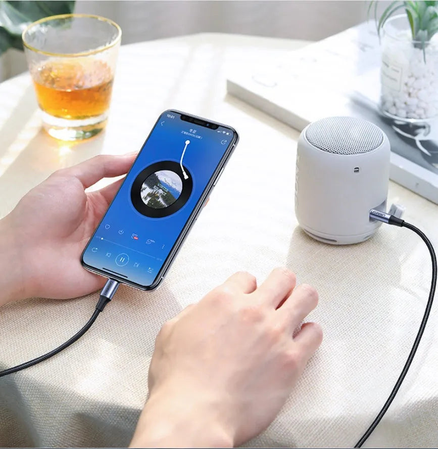 Black braided Apple Lightning to 3.5mm audio adapter cable with aluminium connectors for car use.