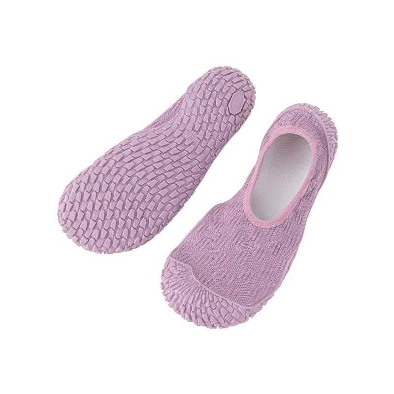 Women's low-top indoor fitness shoes in a solid colour with a mesh upper and soft rubber sole.