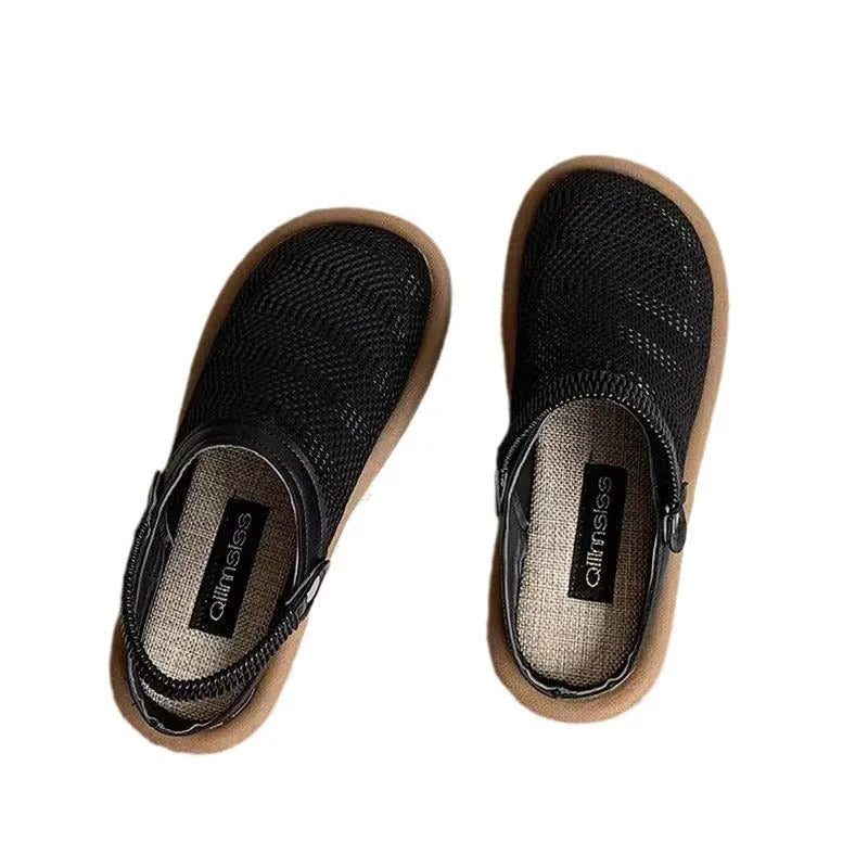 Milky white linen slip-on hole shoes with mesh lining and a light brown rubber sole, shown from the side.