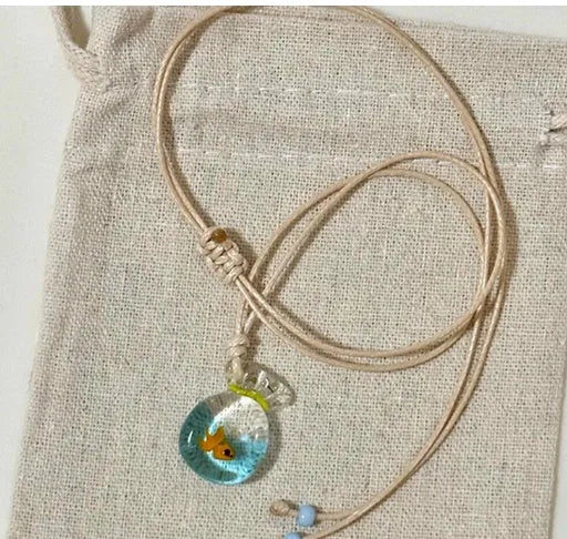Women's pendant necklace with a coloured glaze skirt-shaped joker charm on a cotton and linen clavicle chain.