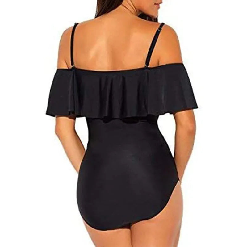 Black women's one-piece swimsuit with side cut-outs and ruffled straps on a tube top.