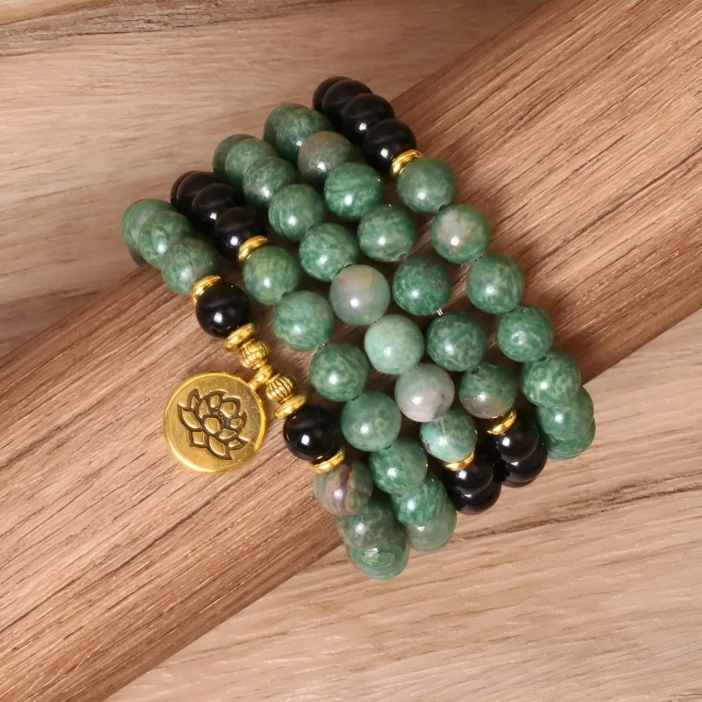 Green and black alloy bead elastic bracelet on a wrist.