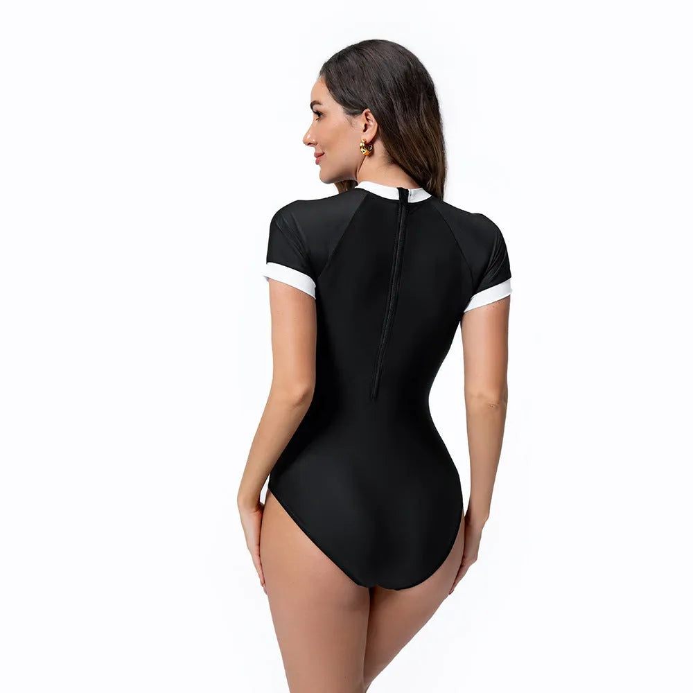 Black and white colour block one-piece swimsuit with short sleeves and back zip, briefs cut, sizes S-XXL